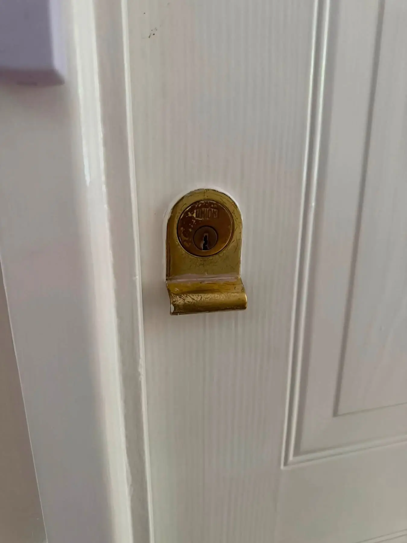 Home security check examining a residential front door lock